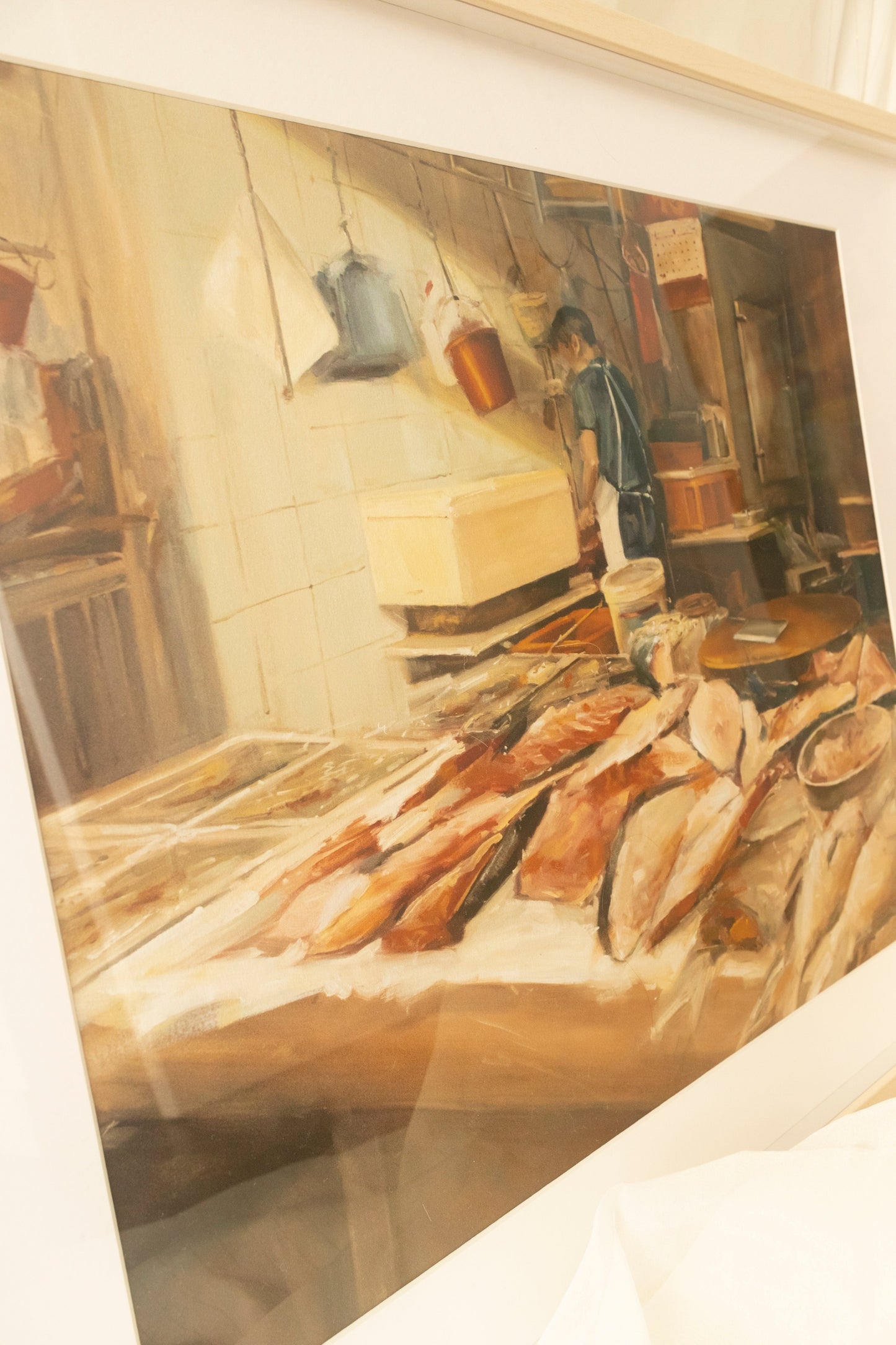 Side view of the limited edition art print titled 'Silver of Flesh' depicting the back of a fishmonger working at his stall, surrounded by an array of glistening frozen fish.